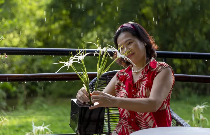 happy woman arranging flowers